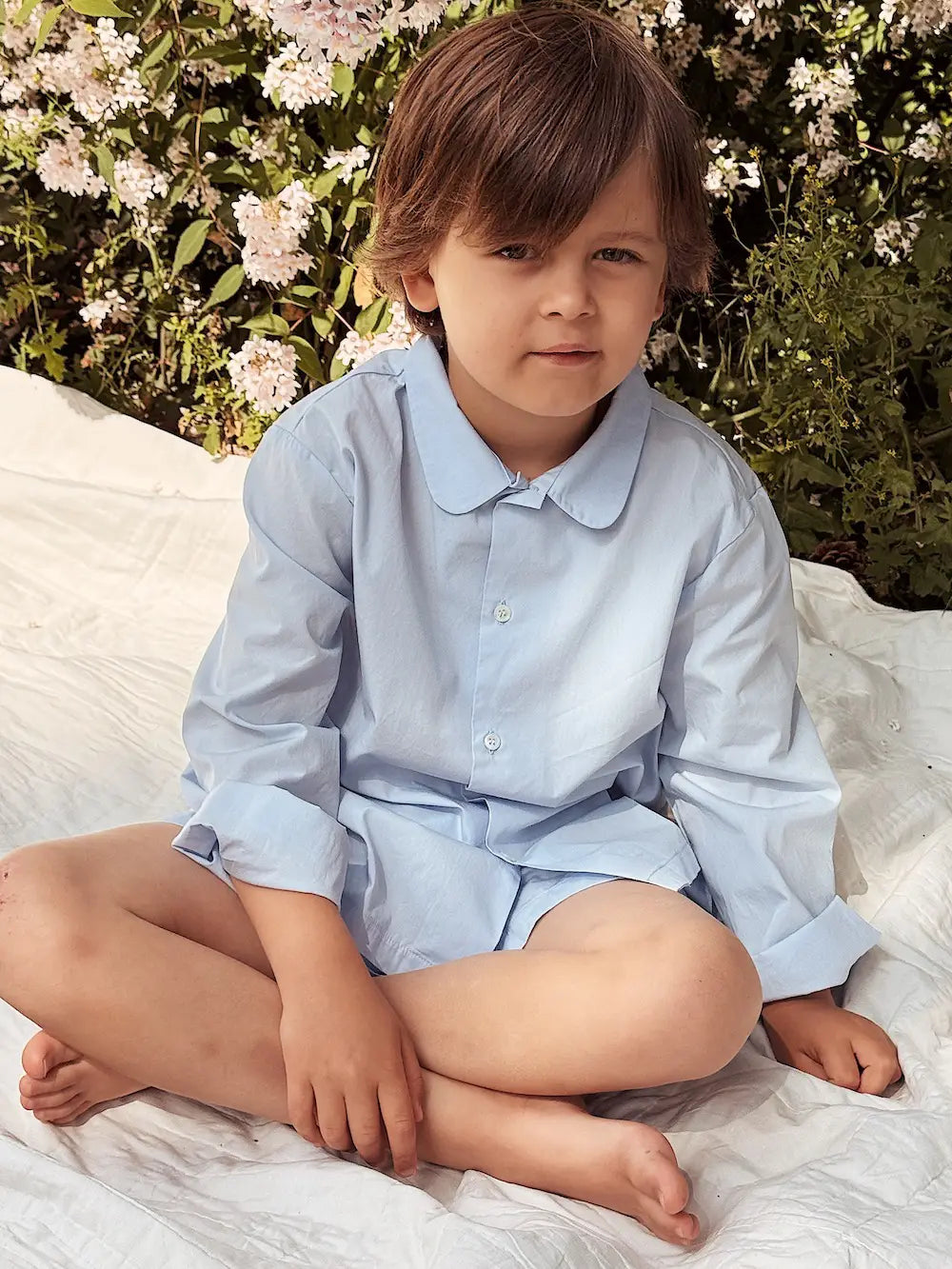 Boy wearing Lalaby summer pyjamas for kids in sky blue organic cotton