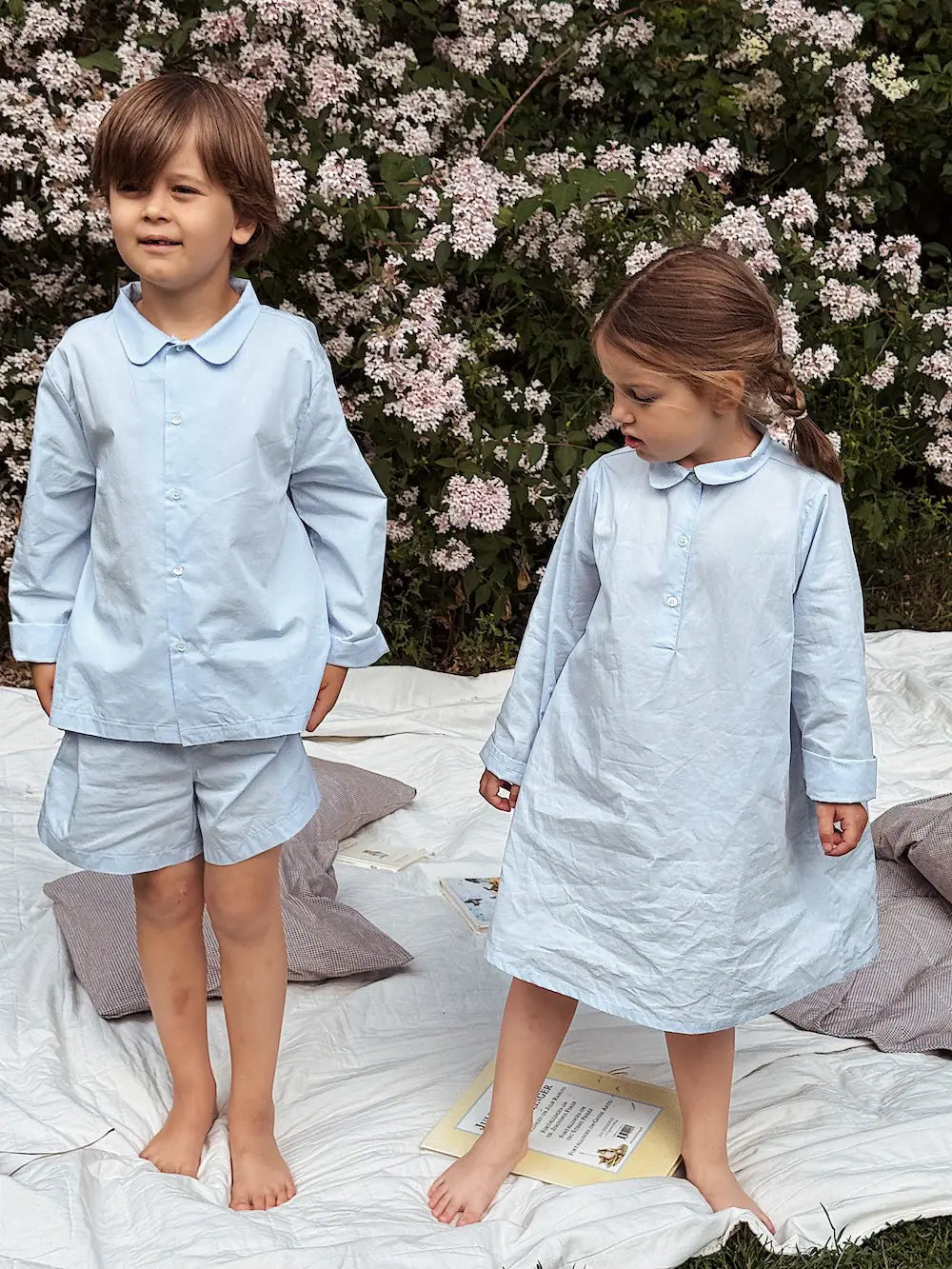 Boy and girl wearing Lalaby summer pyjamas and summer pj dress for kids in sky blue organic cotton