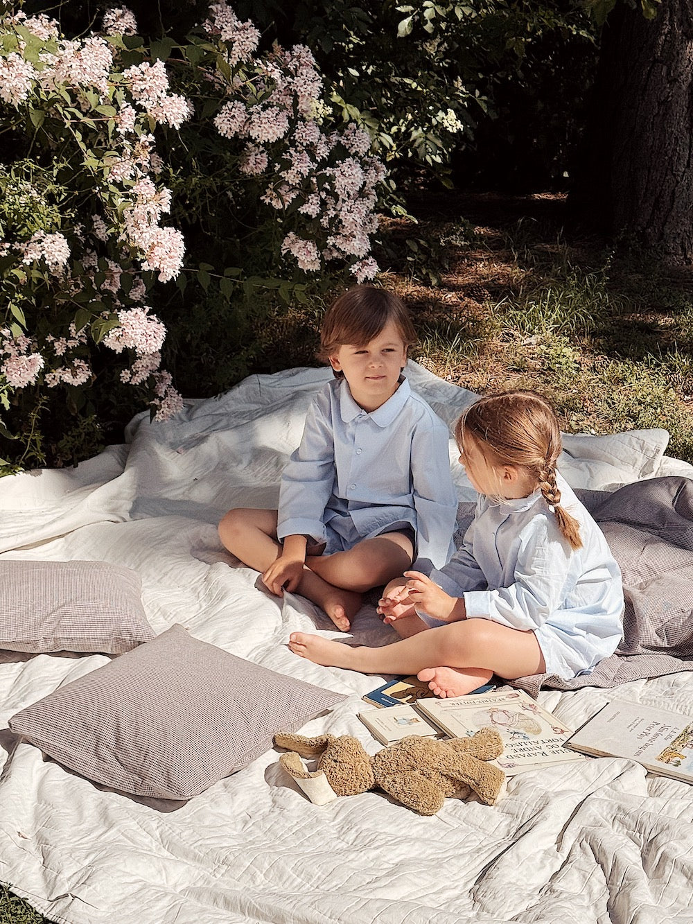 Boy and girl wearing Lalaby summer pyjamas and summer pj dress for kids in sky blue organic cotton