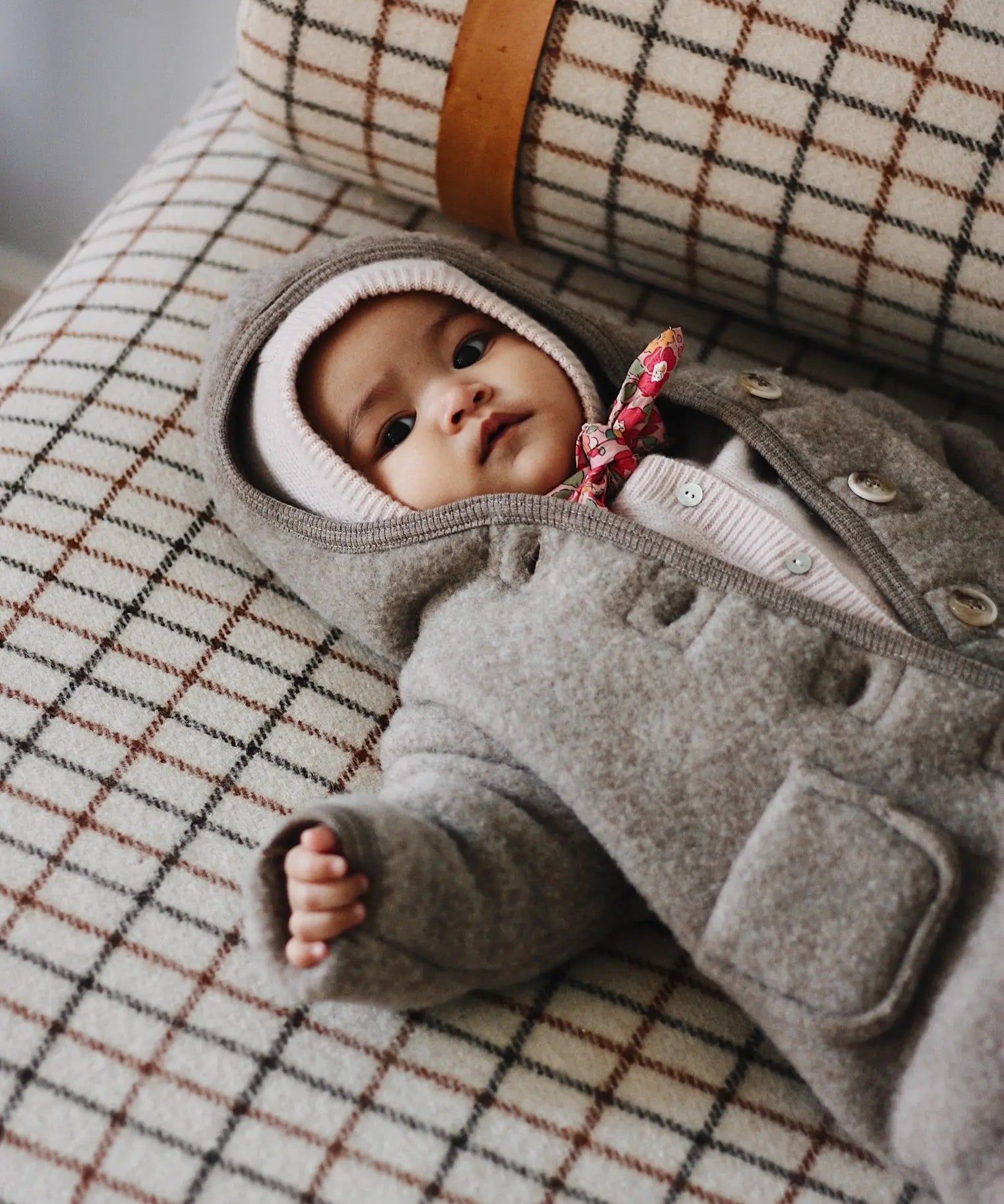 Baby girl wearing Lalaby Teddy onesie for babies in hazel brown merino wool