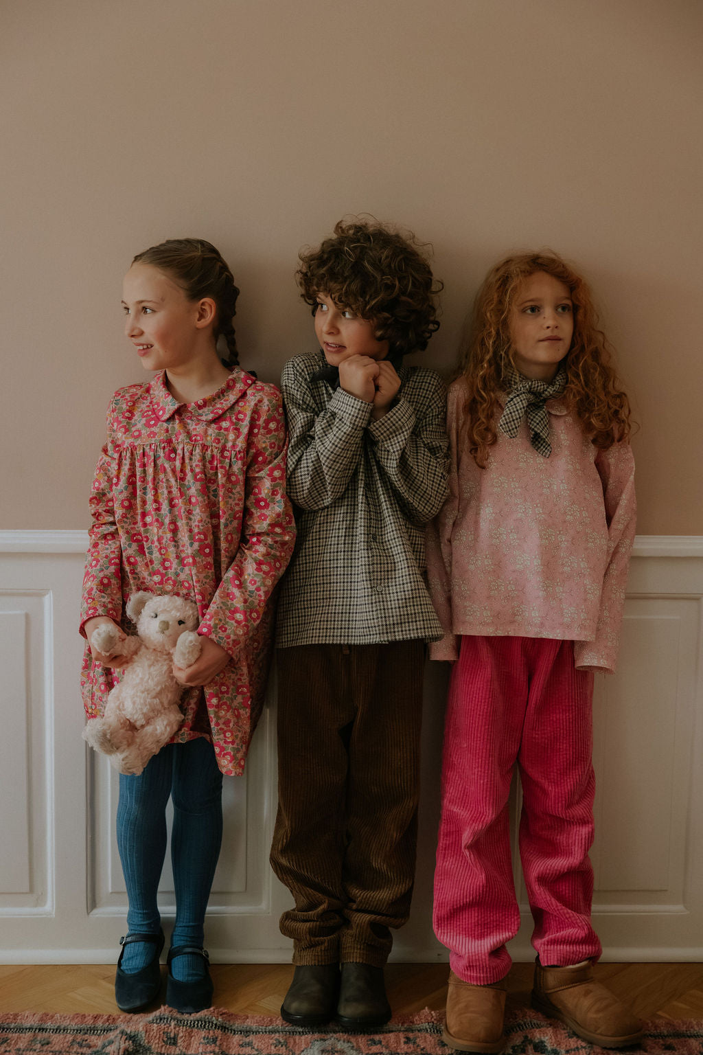 Girl wearing Lalaby Vera scarf for kids and adults in tweedy check organic cotton