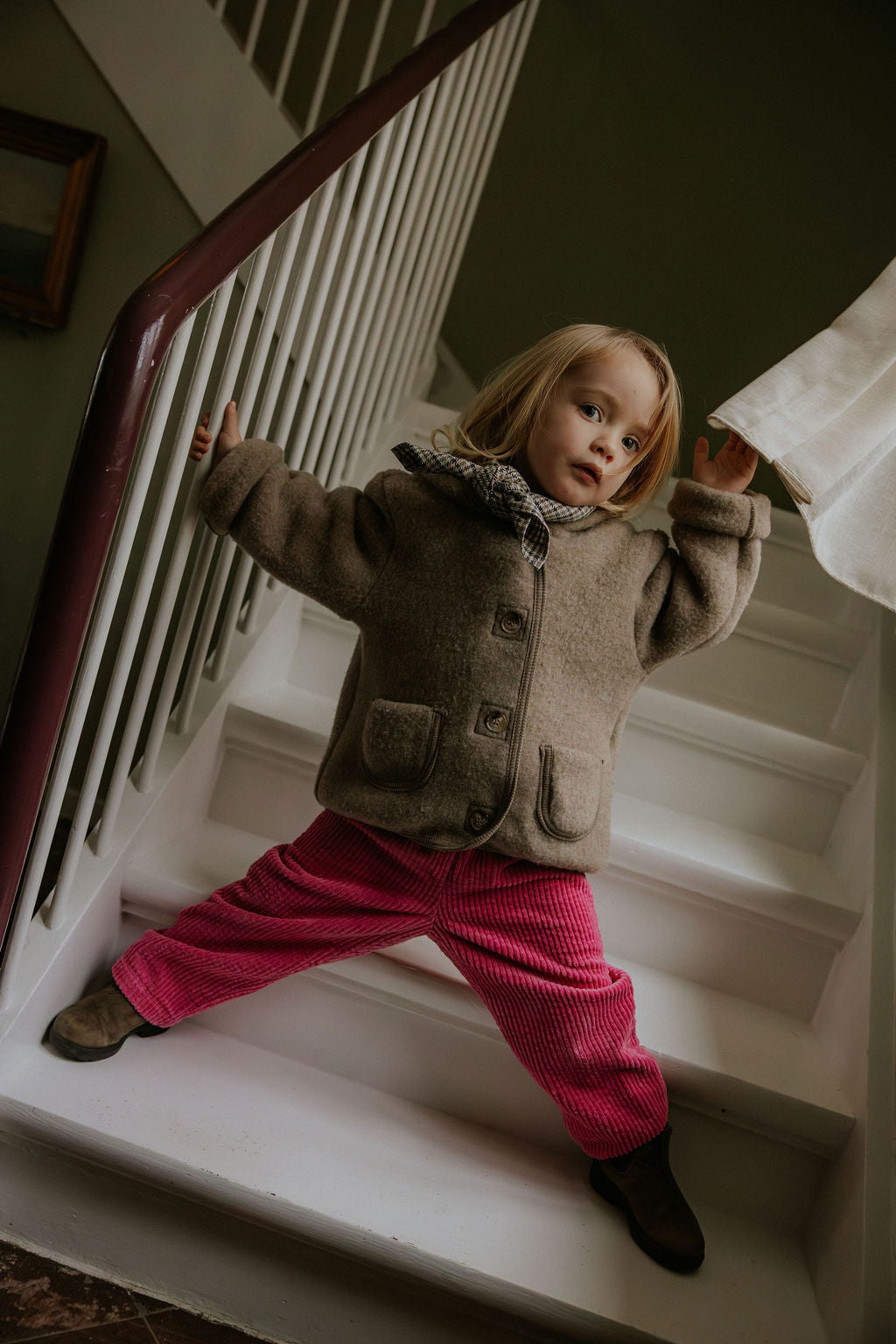 Girl wearing Lalaby Vera scarf for kids and adults in tweedy check organic cotton