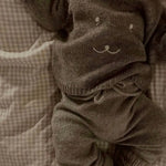Baby wearing Lalaby Winnie jumper for babies in a millet brown baby wool, yak and cashmere blend 