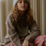 Girl wearing Lalaby Woody beanie in bluey light blue cashmere