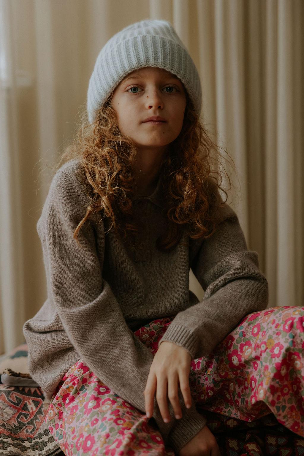 Girl wearing Lalaby Woody beanie in bluey light blue cashmere