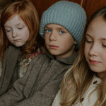 Boy wearing Lalaby Woody beanie in dove blue cashmere